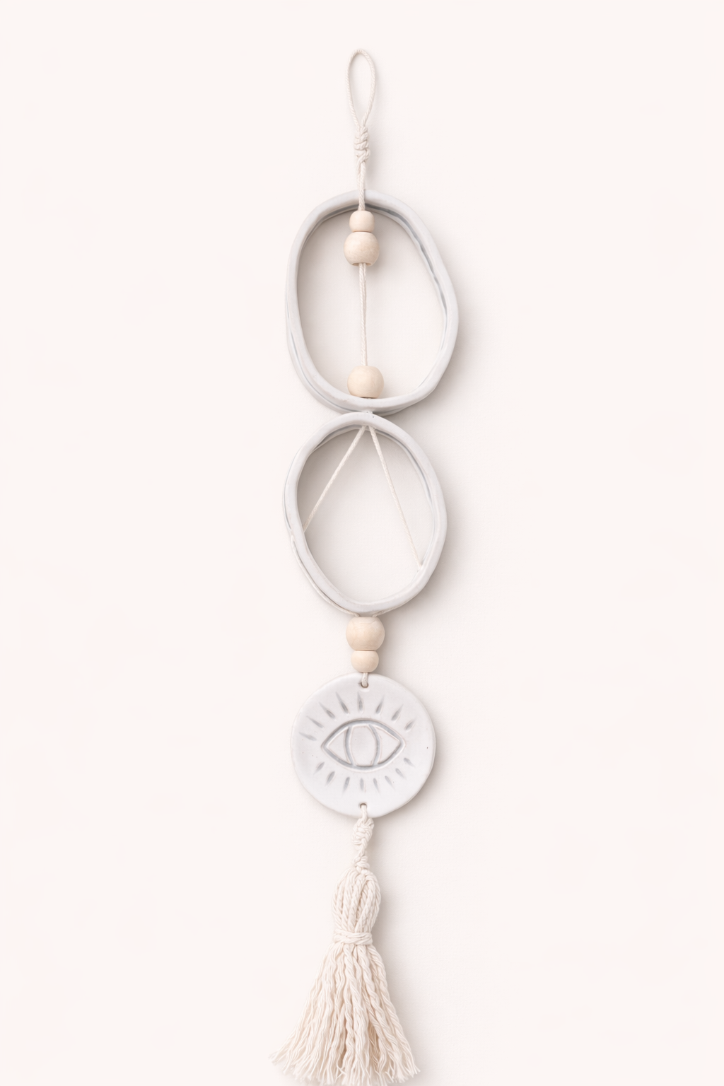 Handmade ceramic wall hanging with tassel