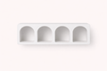 Arched white shelf on wall